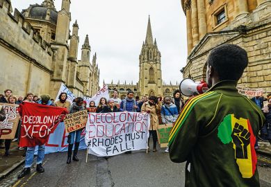 A student in an African-style jumper speaks to demonstrators outside University of Oxford’s All Souls College A student in an African-style jumper speaks to demonstrators outside University of Oxford’s All Souls College