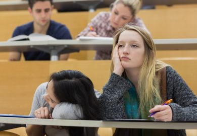 Demotivated students sitting in a lecture hall Demotivated students sitting in a lecture hall