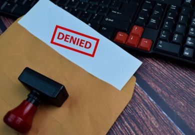 Envelope, with paper sticking out of it, word 'denied' stamped on it Envelope, with paper sticking out of it, word 'denied' stamped on it