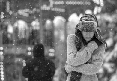 A depressed woman walks in the snow
