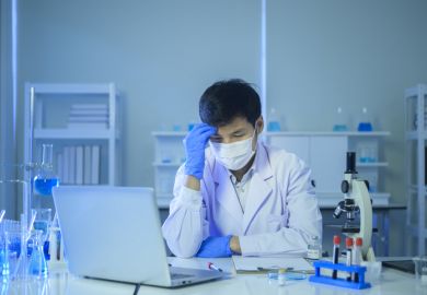 A masked PhD student looking depressed