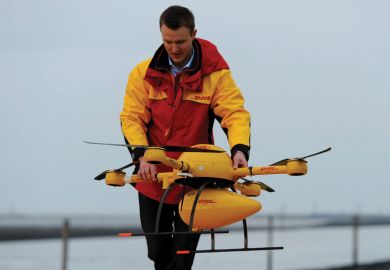 DHL employee prepares PaketKopter drone for delivery DHL employee prepares PaketKopter drone for delivery
