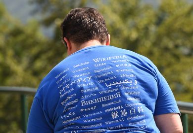 A man attending the Wikimania meeting, wears a shirt reading "Wikipedia" in different languages. A man attending the Wikimania meeting, wears a shirt reading "Wikipedia" in different languages.