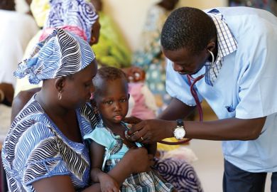 Doctor examining young child patient, Dakar, Senegal Doctor examining young child patient, Dakar, Senegal