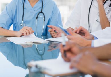 Doctors in a meeting symbolising disagreements about healthcare education