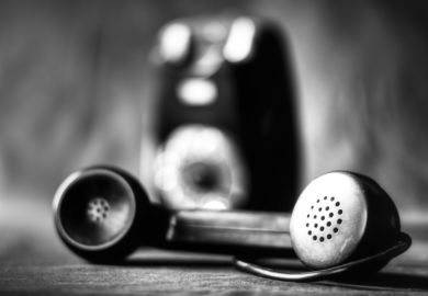 An old-fashioned phone in black and white