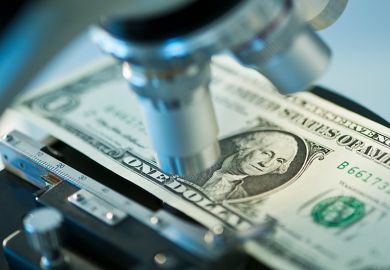 Dollar bill under microscope to illustrate research funding