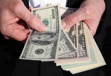 US dollars in a man's hand