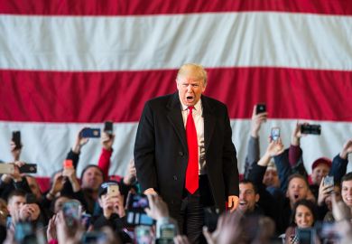 Donald Trump speaks in front of a crowd Donald Trump speaks in front of a crowd