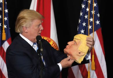 Donald Trump holding mask of his own face Donald Trump holding mask of his own face