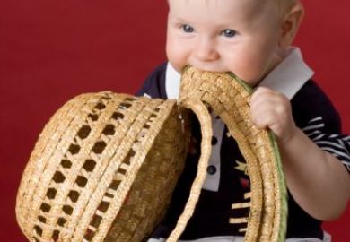 Toddler eating his hat
