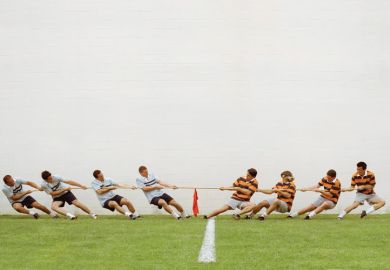 Eight men in tug of war battle Eight men in tug of war battle