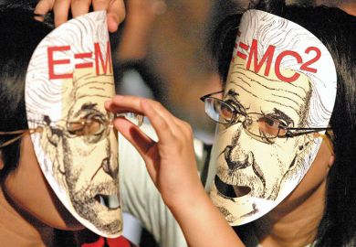 Two people wearing Einstein masks