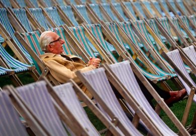 Elderly man sitting alone in rows of deckchairs Elderly man sitting alone in rows of deckchairs