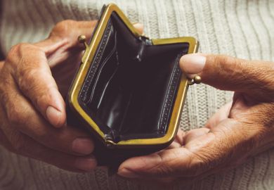 Elderly man holds in his hands an empty wallet