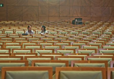 Two women in empty lecture hall