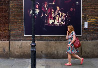 A reproduction of ‘An Experiment on a Bird in the Air Pump’ by Joseph Wright of Derby is displayed in Soho in central London, 2007
