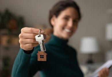 An estate agent holds up house keys