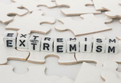 'Extremism' spelled out in letter blocks on jigsaw