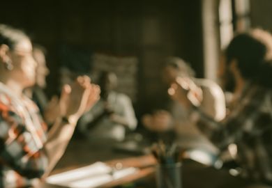An unfocused image of a faculty meeting An unfocused image of a faculty meeting