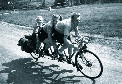 Family riding three-seat bicycle