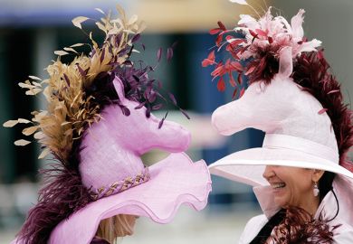 Two women wearing fancy hats