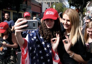 Women draped in stars and stripes take selfie
