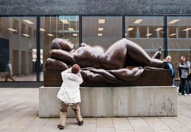 A tourist takes pictures of a sculpture of a voluptuous naked woman in Vaduz, Liechtenstein A tourist takes pictures of a sculpture of a voluptuous naked woman in Vaduz, Liechtenstein