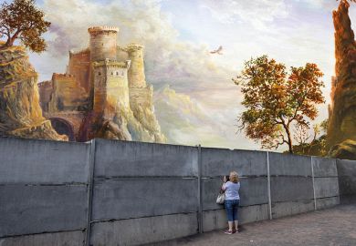 A woman peeks through a grey wall to a magnificent castle on the other side