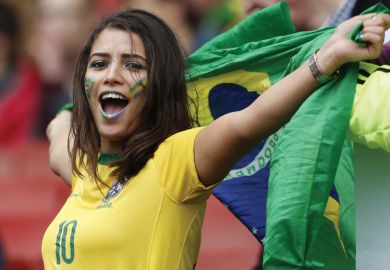 Female Brazilian football/soccer fan celebrating with flag of Brazil, Best universities in Latin America Female Brazilian football/soccer fan celebrating with flag of Brazil, Best universities in Latin America