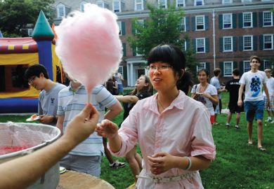 Female student buying cotton candy, Yale Summer School Female student buying cotton candy, Yale Summer School