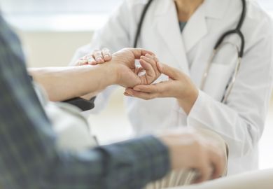 Female doctor and senior man illustrating news article about increase in admissions of women to Japanese medical schools