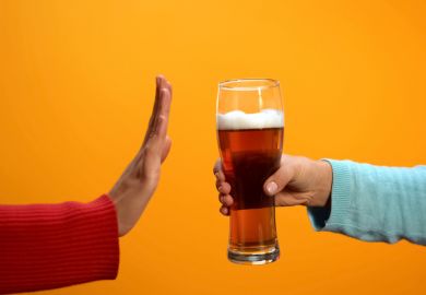 Female rejecting beer glass showing stop gesture