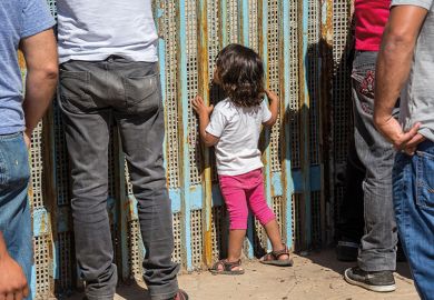 people stand at a fence people stand at a fence