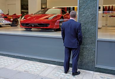 Man window shopping at Ferrari showroom
