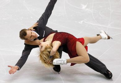 Figure skaters striking pose during competition Figure skaters striking pose during competition