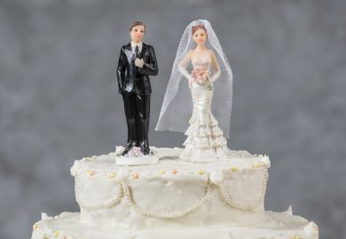Figurines of the bride and groom on a wedding cake Figurines of the bride and groom on a wedding cake