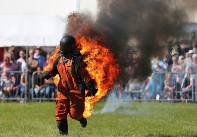 Man in hazard suit on fire Man in hazard suit on fire