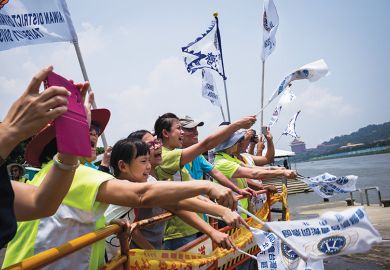 Teammates cheer during a dragon boat race in Taipei