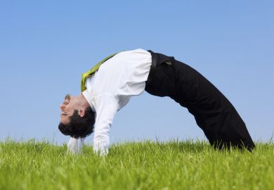 A flexible businessman bends over backwards