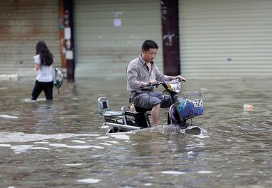 Man riding a bicycle in flood