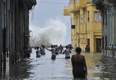 Cubans wade through a flooded street in Havana after Hurricane Irma swept through the country in 2017 Cubans wade through a flooded street in Havana after Hurricane Irma swept through the country in 2017