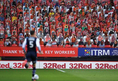 Soccer player in front of carcboard cutout crowd. Shows diverse supporters to relate to subject diversity improving globally.