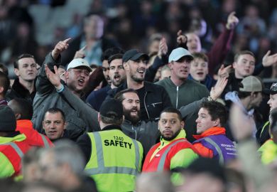 Football fans taunt fans of opposing side Football fans taunt fans of opposing side