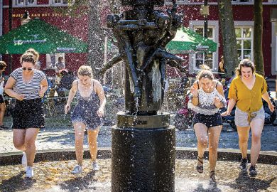 Women cool off in a fountain in Maastricht, on August 8, 2020