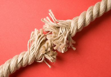 Frayed rope on red background Frayed rope on red background