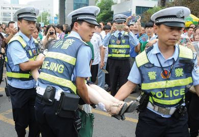 Gao kao exam in China. Policemen rescue woman who fainted