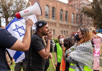 An Israeli man, holding a flag, argues with a pro-Palestinian student as pro-Palestinian students gather to protest against Israeli attacks on Gaza at University of California (UCLA) in Los Angeles, California, United States on April 25, 2024
