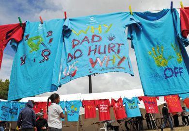 T-shirts painted with messages of support hang on clothes lines, South Africa. Part of the 16 Days of Activism of No Violence Against Women and Children campaign