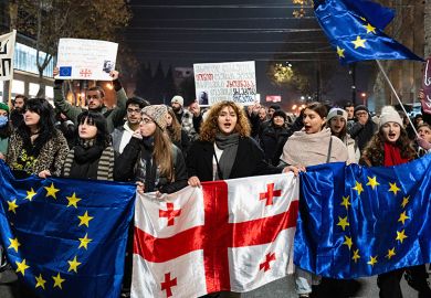 Georgia pro-Europe demonstrators hold Georgian and European flags during a protest against the Government's postponement of European Union accession talks until 2028, outside the Parliament in central Tbilisi, Georgia, on December 11, 2024 Georgia pro-Europe demonstrators hold Georgian and European flags during a protest against the Government's postponement of European Union accession talks until 2028, outside the Parliament in central Tbilisi, Georgia, on December 11, 2024